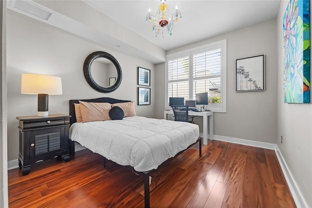 bedroom with dark wood-type flooring and a notable chandelier