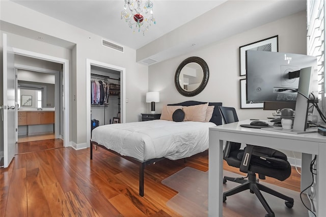 bedroom featuring a chandelier and hardwood / wood-style flooring