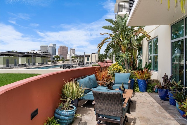 balcony featuring a patio area and a city view