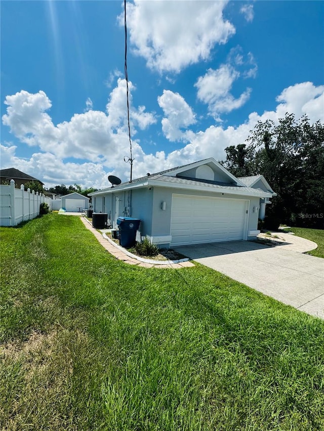 view of side of home with a garage and a lawn