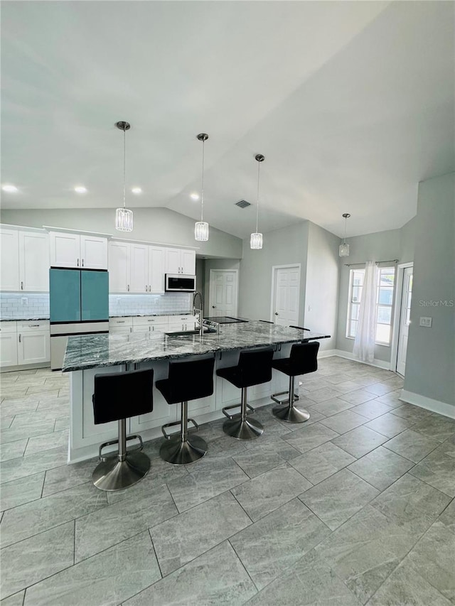 kitchen featuring stainless steel appliances, backsplash, and white cabinets