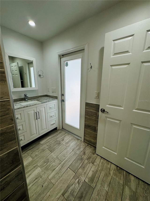 bathroom featuring vanity and hardwood / wood-style flooring