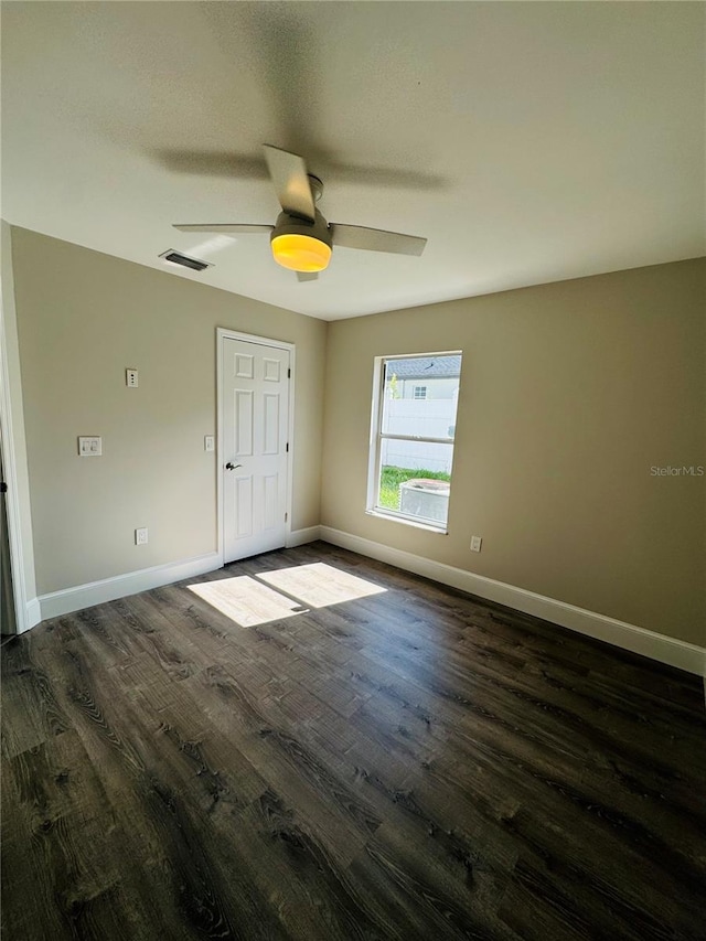 unfurnished bedroom with ceiling fan and dark hardwood / wood-style flooring