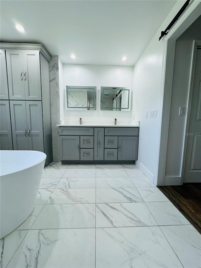 bathroom with a tub and vanity