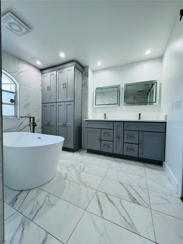 bathroom featuring a tub to relax in and vanity