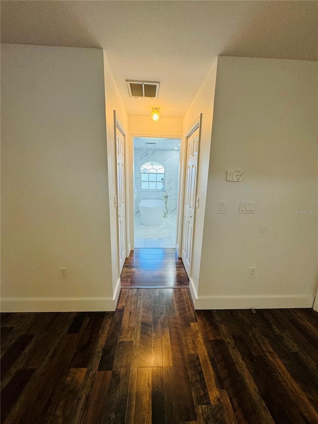 hall with dark wood-type flooring