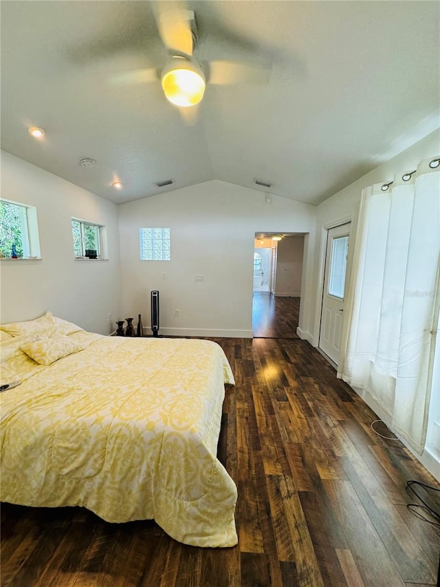 bedroom with ceiling fan, dark hardwood / wood-style floors, and vaulted ceiling