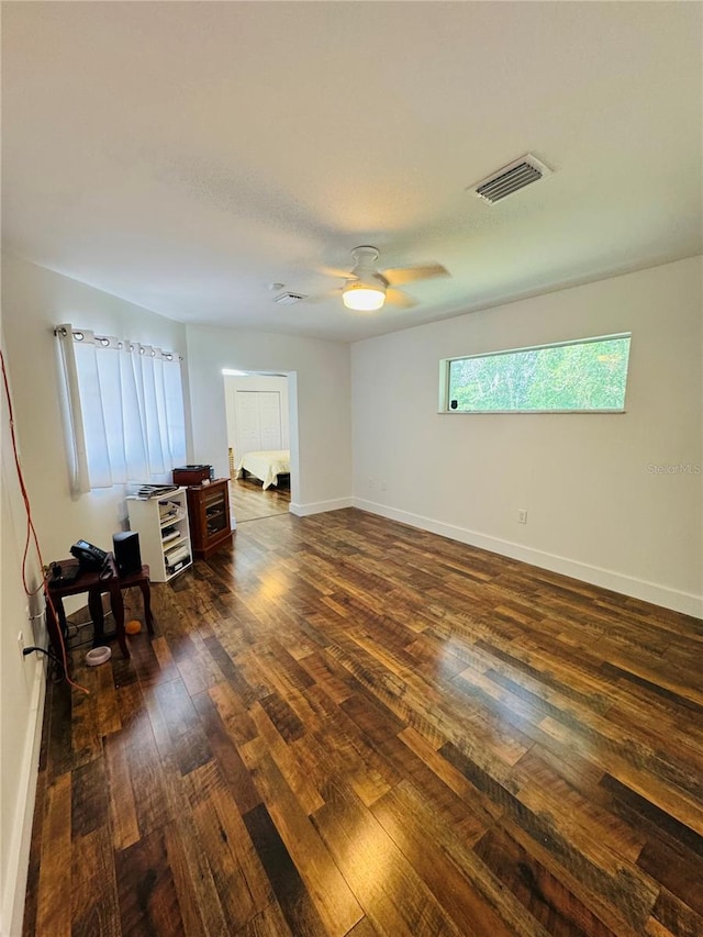 unfurnished bedroom with ceiling fan and dark hardwood / wood-style floors