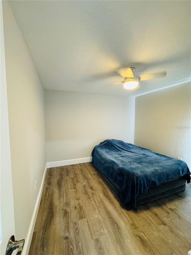 bedroom featuring a textured ceiling, ceiling fan, and hardwood / wood-style flooring