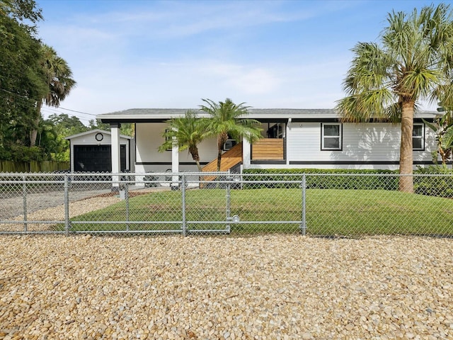 ranch-style home featuring a front lawn, an outdoor structure, and a garage