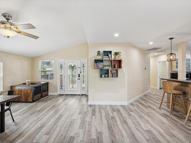 living room featuring lofted ceiling, light hardwood / wood-style flooring, and ceiling fan