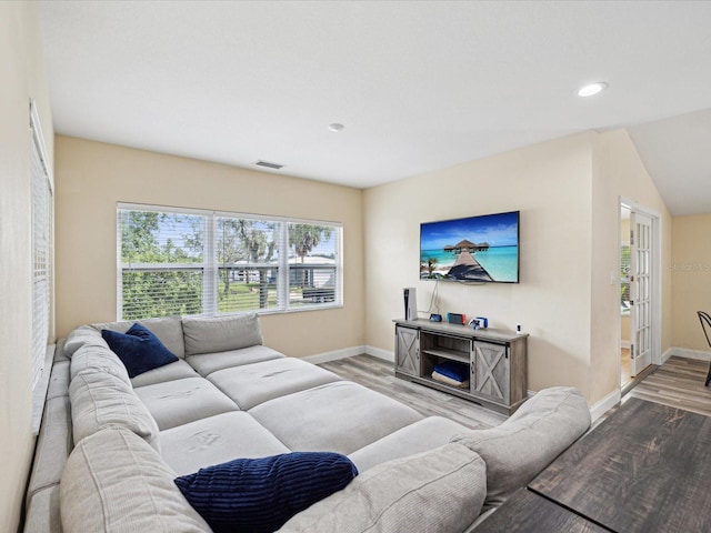 living room with lofted ceiling and hardwood / wood-style flooring