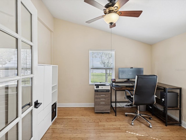 home office featuring lofted ceiling, light hardwood / wood-style floors, and ceiling fan