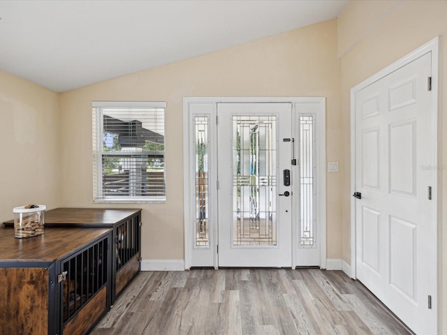 foyer with lofted ceiling and light hardwood / wood-style floors