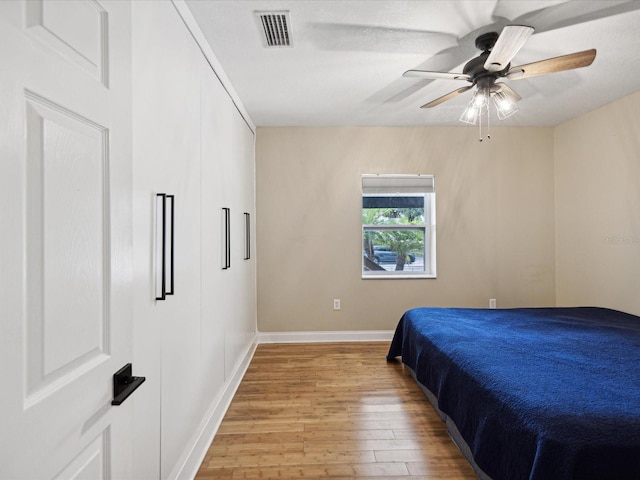 bedroom featuring light hardwood / wood-style floors and ceiling fan