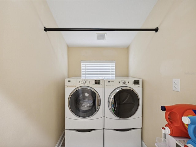 clothes washing area featuring separate washer and dryer