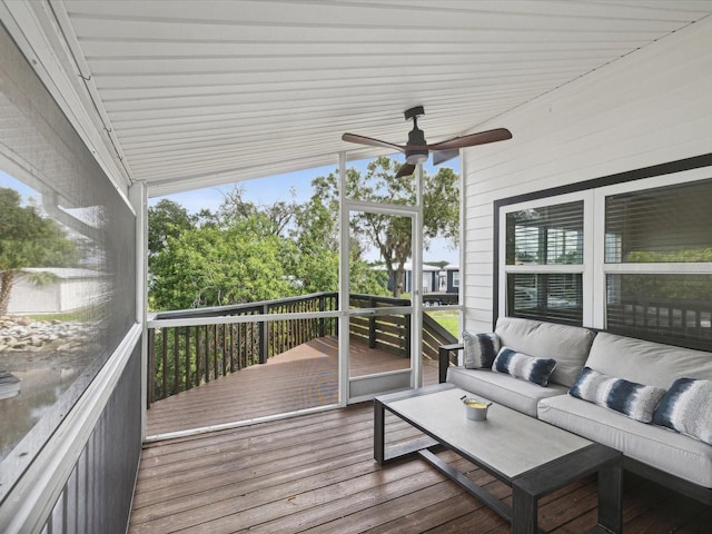 wooden deck featuring an outdoor living space and ceiling fan