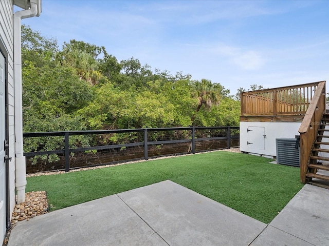 view of yard featuring a patio, central AC, and a deck