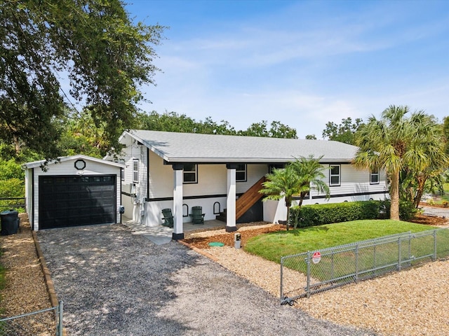 ranch-style home with an outbuilding and a garage