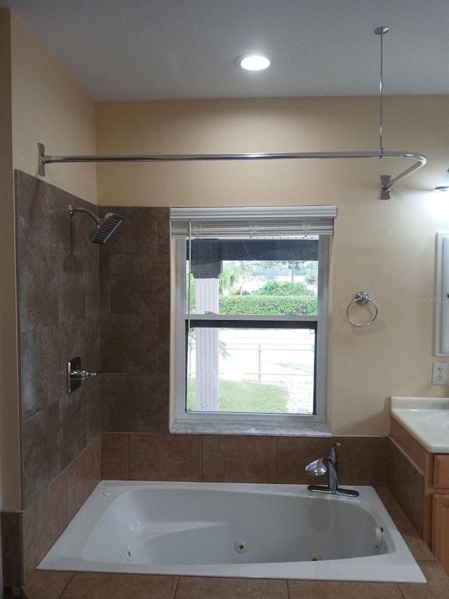 bathroom with vanity and tiled shower / bath