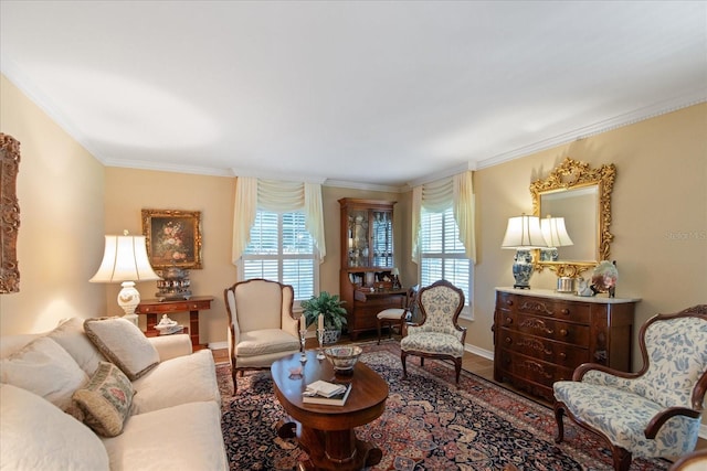 living area featuring ornamental molding, a healthy amount of sunlight, baseboards, and wood finished floors