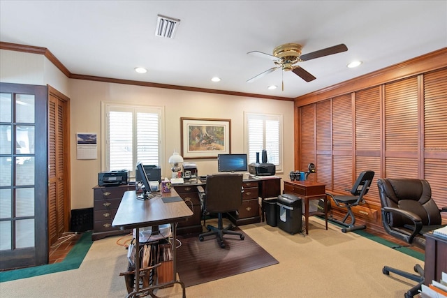 carpeted office space with a healthy amount of sunlight, ceiling fan, and ornamental molding