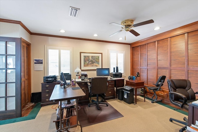 office area featuring light colored carpet, visible vents, and crown molding