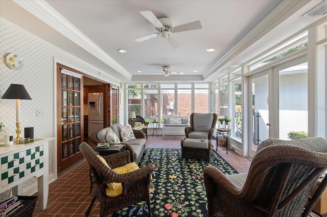 sunroom featuring a tray ceiling and visible vents