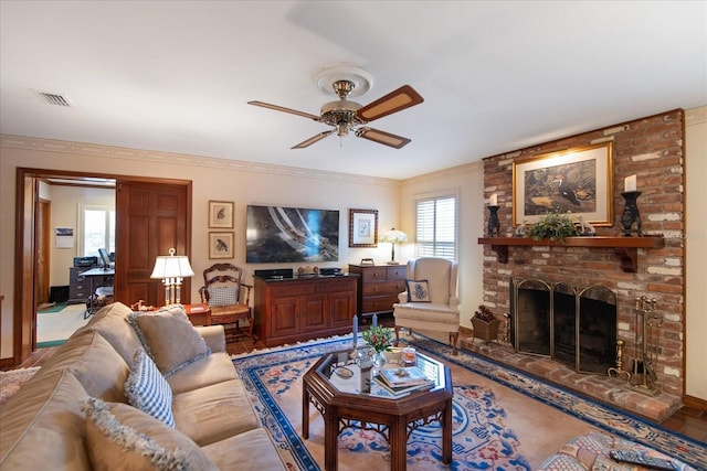 living room featuring crown molding, a brick fireplace, and ceiling fan