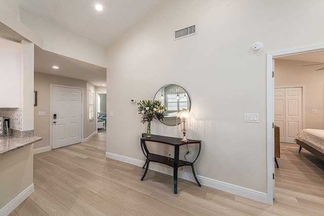 hall featuring recessed lighting, visible vents, light wood-style flooring, and baseboards