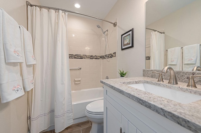 full bathroom with wood finished floors, toilet, vanity, and shower / bath combo