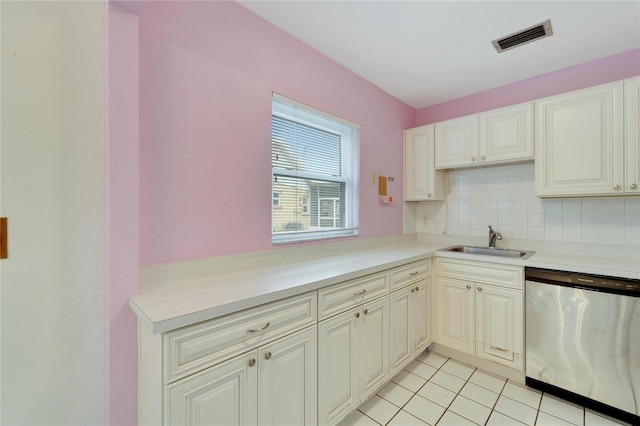 kitchen featuring light tile patterned floors, backsplash, stainless steel dishwasher, and sink