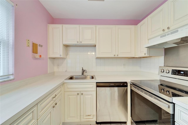 kitchen with appliances with stainless steel finishes, tasteful backsplash, and sink