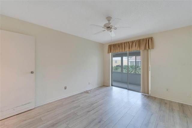 empty room featuring ceiling fan, a textured ceiling, and light hardwood / wood-style flooring