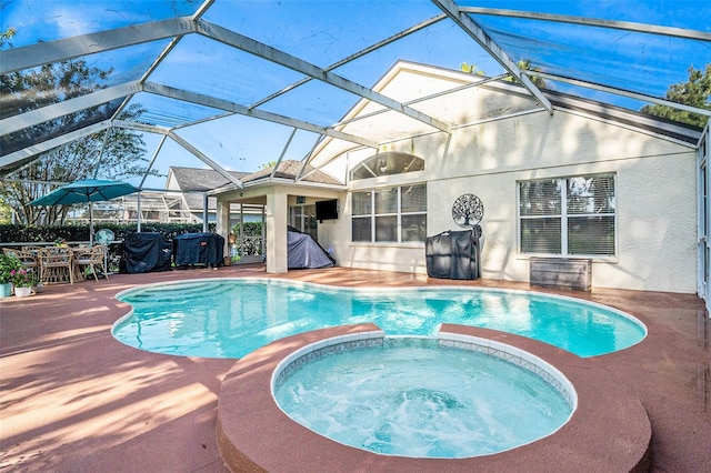 view of pool with glass enclosure, an in ground hot tub, and a patio