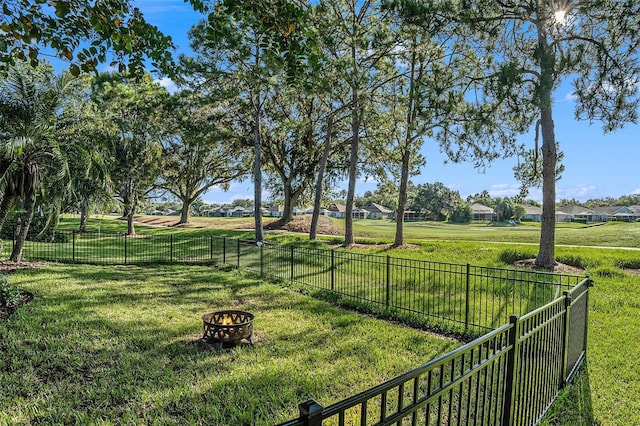 view of yard featuring a fire pit and fence