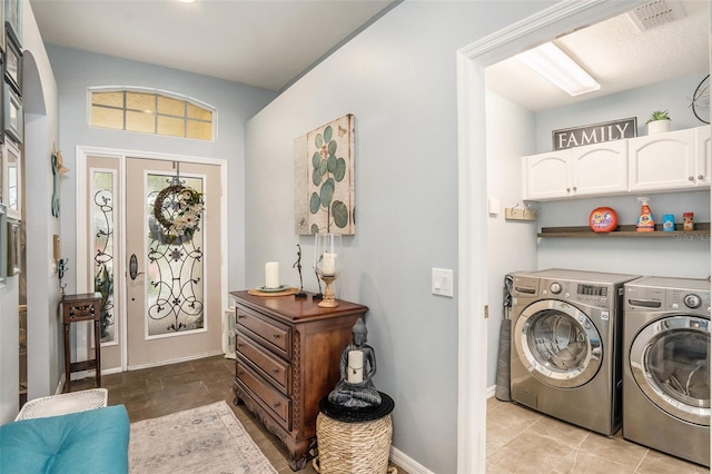 laundry area featuring cabinet space, visible vents, baseboards, and independent washer and dryer