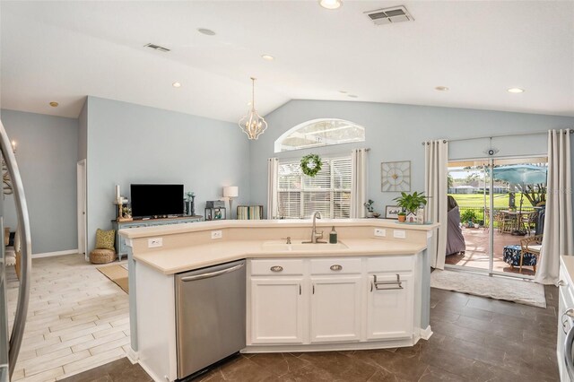 kitchen with a center island with sink, stainless steel dishwasher, sink, and lofted ceiling