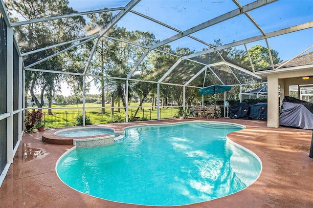 view of swimming pool with glass enclosure, a pool with connected hot tub, and a patio