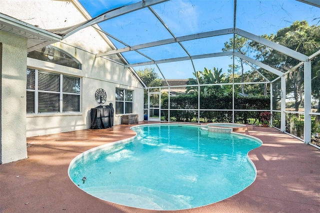 view of swimming pool with a lanai, a patio, and an in ground hot tub