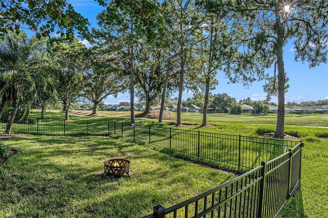 view of yard with an outdoor fire pit