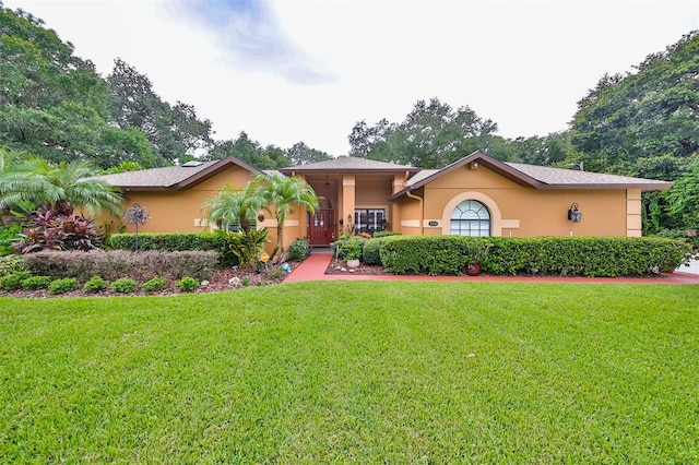 ranch-style home featuring a front yard