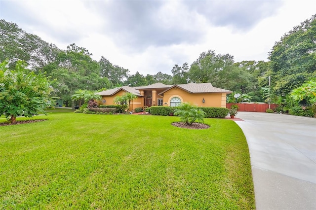 ranch-style house featuring a front lawn