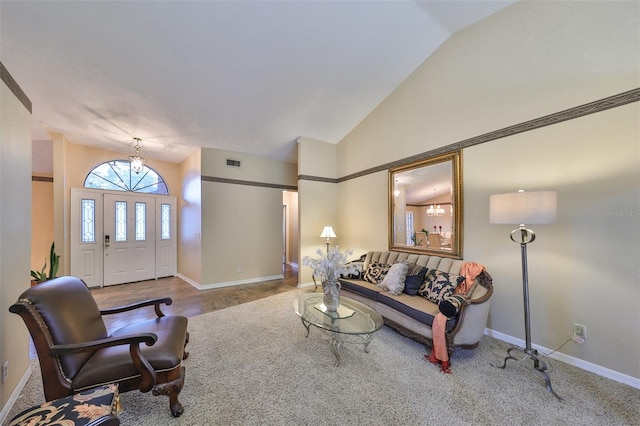 living room with high vaulted ceiling and carpet