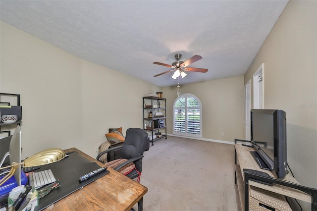 office area featuring a textured ceiling, ceiling fan, and carpet