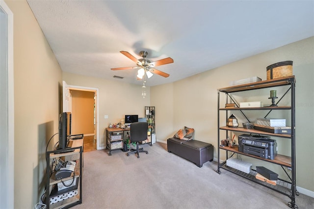 office area featuring light carpet and ceiling fan