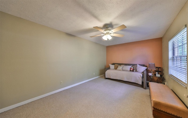 unfurnished bedroom featuring a textured ceiling, carpet flooring, and ceiling fan