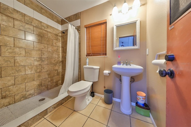 bathroom with toilet, walk in shower, and tile patterned floors