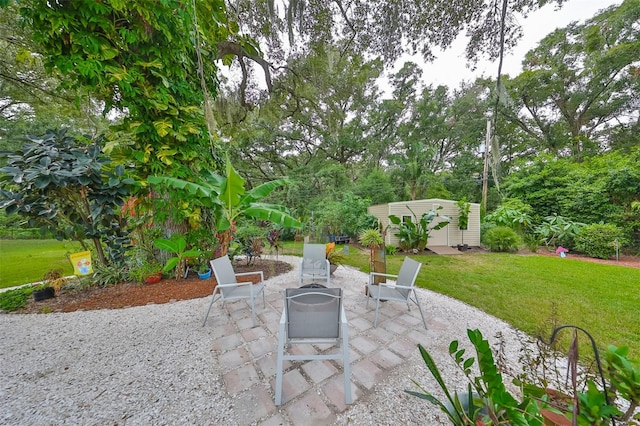 view of patio with a shed and an outdoor fire pit