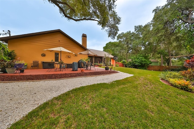 exterior space featuring a lawn and a patio